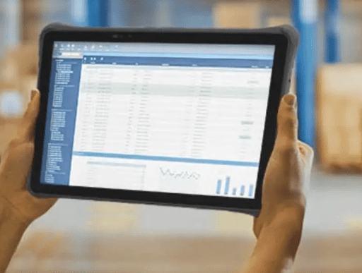 Person holding tablet displaying spreadsheet data. Person holding tablet displaying spreadsheet data.