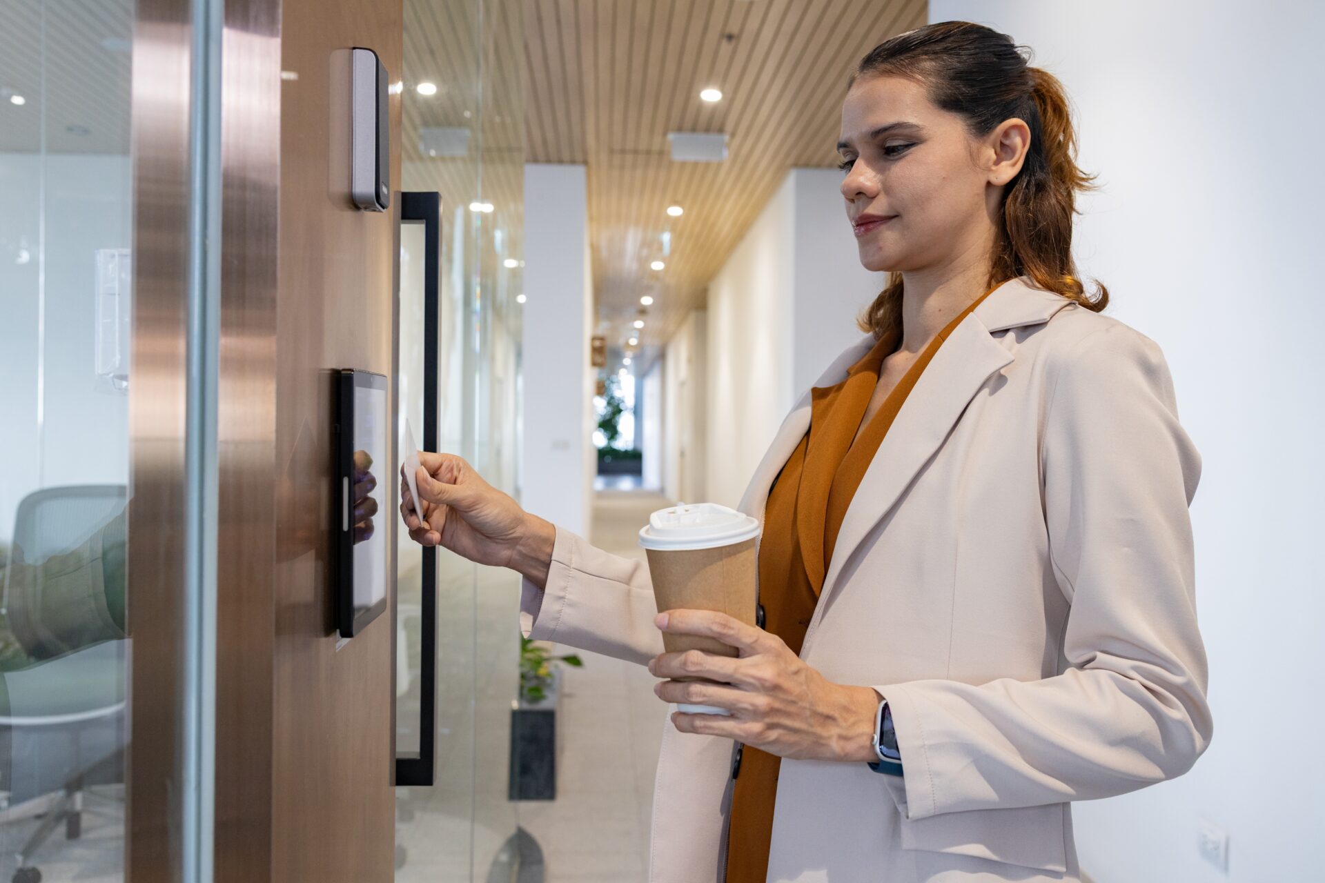 Woman swiping keycard at office door